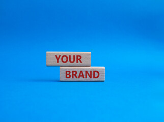 Your Brand symbol. Concept word Your Brand on wooden blocks. Beautiful blue background. Business and Your Brand concept. Copy space