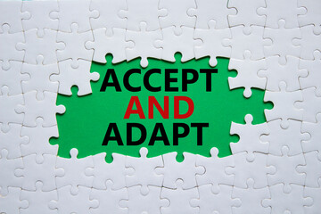 Accept or adapt symbol. Concept words Accept and adapt on white puzzle. Beautiful green background....
