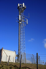 5G tower against a blue sky.