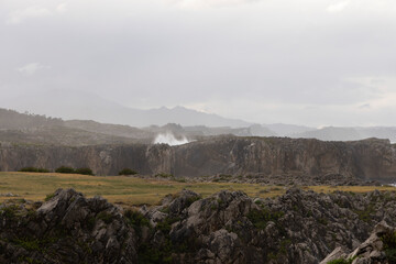 Landscape of Bufones de Pria in Asturias coast on a cloudy day with rough seas and wave spray