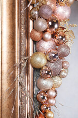 A close-up of Christmas balls decoration frame (peach, golden, pink colors) 