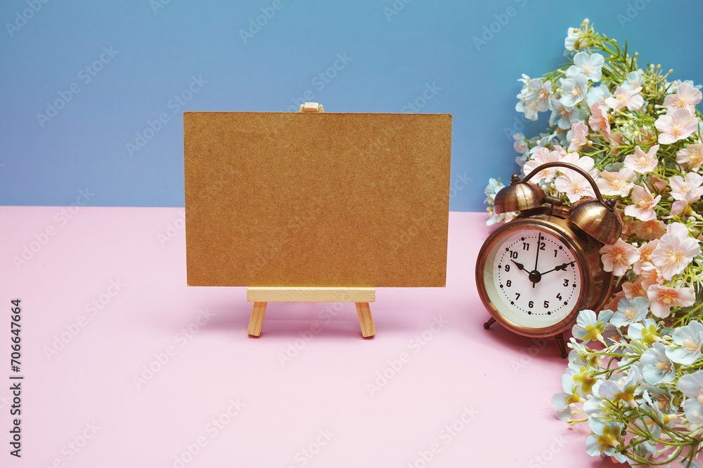 Aufkleber empty card space for text message with alarm clock and flower decoration on blue and pink background