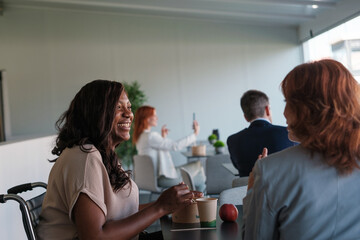 Group of businesspeople eating together during break time in a coworking room