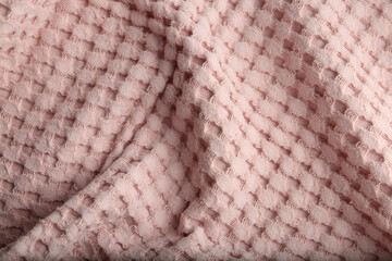 Texture of soft light pink fabric as background, closeup