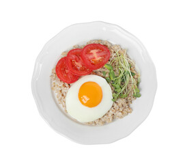 Delicious boiled oatmeal with fried egg, tomato and microgreens isolated on white, top view