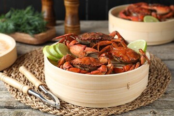 Delicious boiled crabs with lime and dill served on wooden table