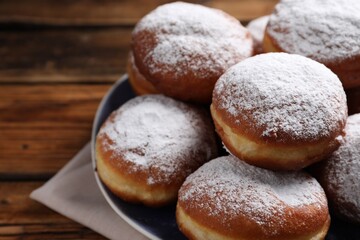 Delicious sweet buns with powdered sugar on table, closeup