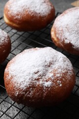 Delicious sweet buns with powdered sugar on table, closeup