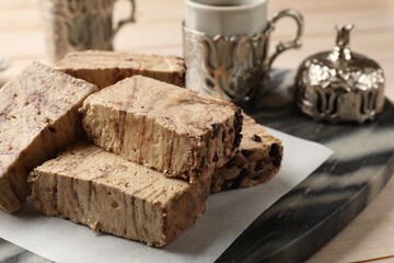Tasty chocolate halva on wooden table, closeup