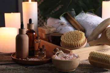 Composition with different spa products and candles on wooden table