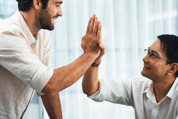 Diverse group of office employee worker high five after making agreement on strategic business...