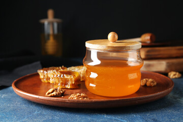 Jar of sweet honey and combs on table