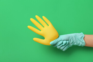Woman with medical gloves on green background
