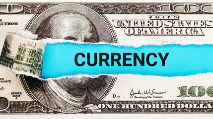Currency. The word Currency in the background of the US dollar. Financial Markets Concept....