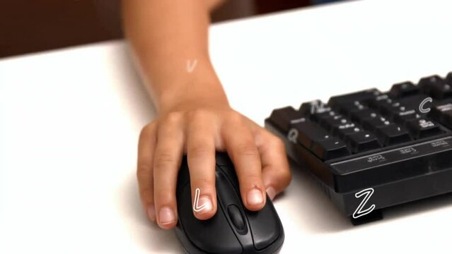 Animation of letters over hand of biracial schoolboy using computer mouse at school