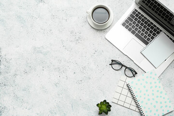 Composition with eyeglasses, laptop, plant and notepad on light background