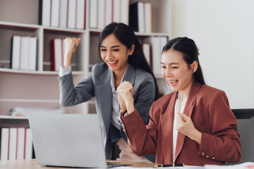 Group of young asian businesswoman working and brainstorming in workshop and analyzing marketing reports startup project infographics in the office.
