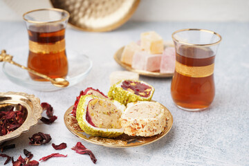 Plate with tasty Turkish Delight on light background