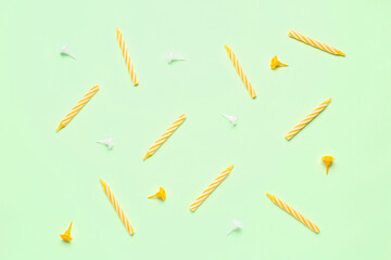 Yellow birthday candles on green background
