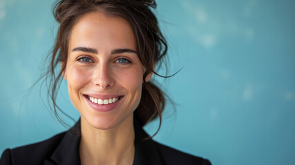 CloseUp Portrait of a smiling business woman against a blue studio background - obrazy, fototapety, plakaty
