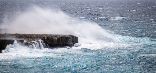 Seascape in a storm. Storm at sea. View of big waves in the ocean hitting the rocks with big...