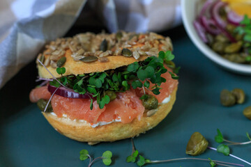 Gourmet Smoked Salmon Bagel With Fresh Herbs and Capers on a Stylish Ceramic Plate