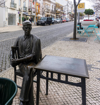 Loul&eacute;, Portugal, 14th December 2019. The seated statue of Antonio Aleixo (1899-1949)  Portuguese poet, outside Caf&eacute; Calcinha, a caf&eacute; he frequented.