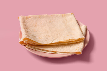 Plate with fresh thin lavash on pink background