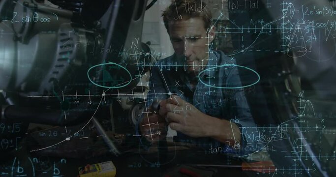 Animation of mathematical equations over caucasian male mechanic working on motorbike