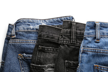Different stylish denim jeans on white background