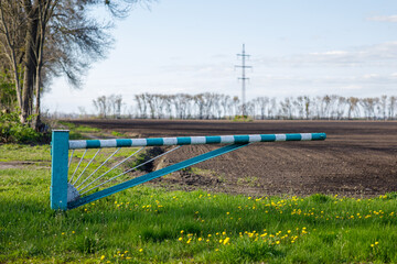 Fototapeta premium the barrier to the field is ready for sowing