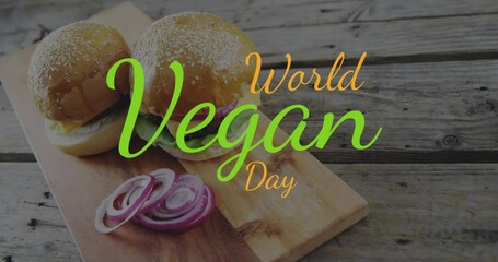 Animation of world vegan day text in orange and green over vegetarian burgers and red onion