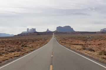 Fototapeta na wymiar Road in the desert leading to rock formations