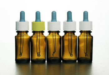 Brown bottle with cap and pipette for the perfume industry,