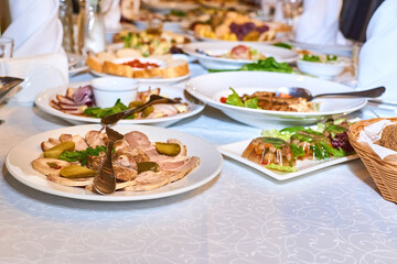 Served banquet festive table with various appetizers and salads