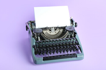 Vintage typewriter on lilac background