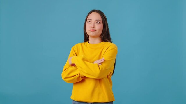 Woman making facepalm and crossing arms on blue background