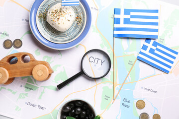 Flags of Greece, magnifying glass, wooden car and euro coins on city map. Tourism concept