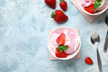 Bowls of strawberry ice cream and spoons on grunge background