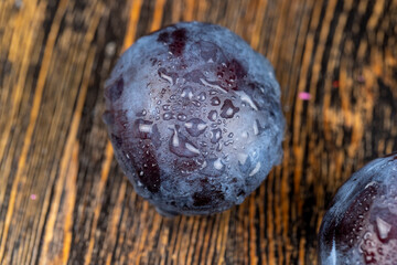 Wet purple plum on the table, fresh harvest