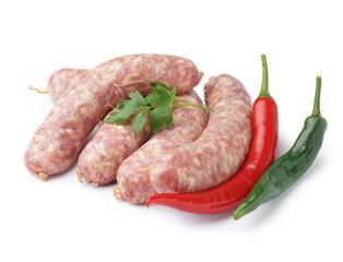 Raw fresh sausages, parsley and hot peppers on white background