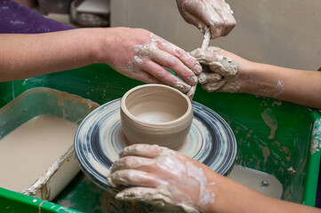 Clay, pottery or hands in designer workshop working on an artistic cup or mug mold in small business studio. Hand of creative artist or worker manufacturing handicraft products in sculpture
