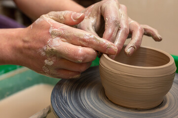 Clay, pottery or hands in designer workshop working on an artistic cup or mug mold in small business studio. Hand of creative artist or worker manufacturing handicraft products in sculpture