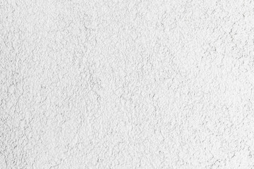 White concrete wall with rough plaster layer. Front view, background