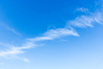 Naklejka na ściany i meble Line of cirrus clouds in blue sky, natural background photo texture