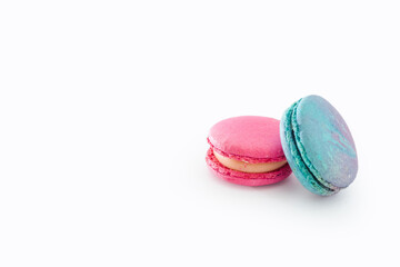 Tasty colorful macarons isolated on white background. Sweet macaroons dessert. Two multi-colored blue and pink macaroons. French pastry, almond cookies from egg whites.