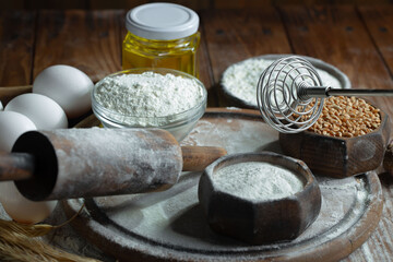 Kneading dough with flour and eggs, on an old background