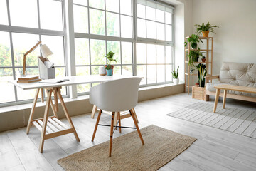 Modern workplace with houseplants in living room interior
