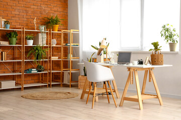 Interior of home office with workplace and shelf unit