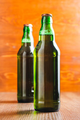 Bottles of beer on wooden table.